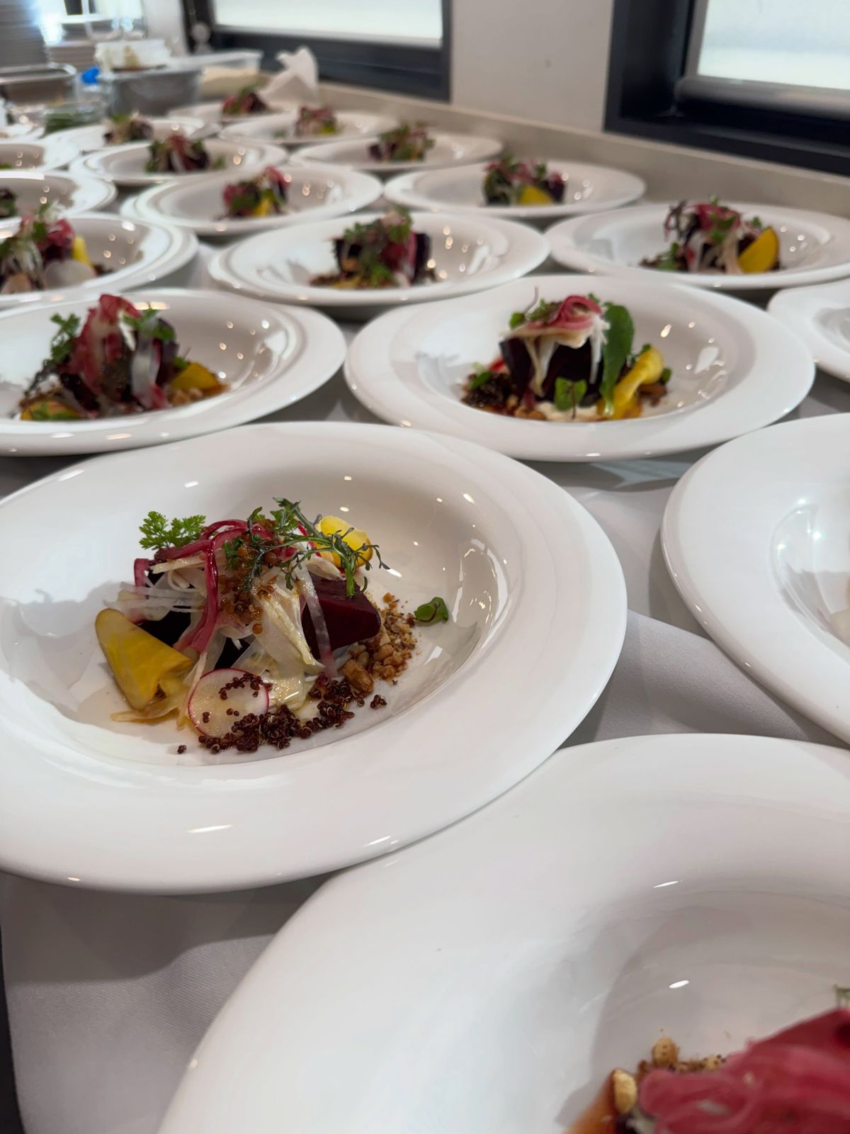 Rows of plated entrées ready for a corporate dinner service