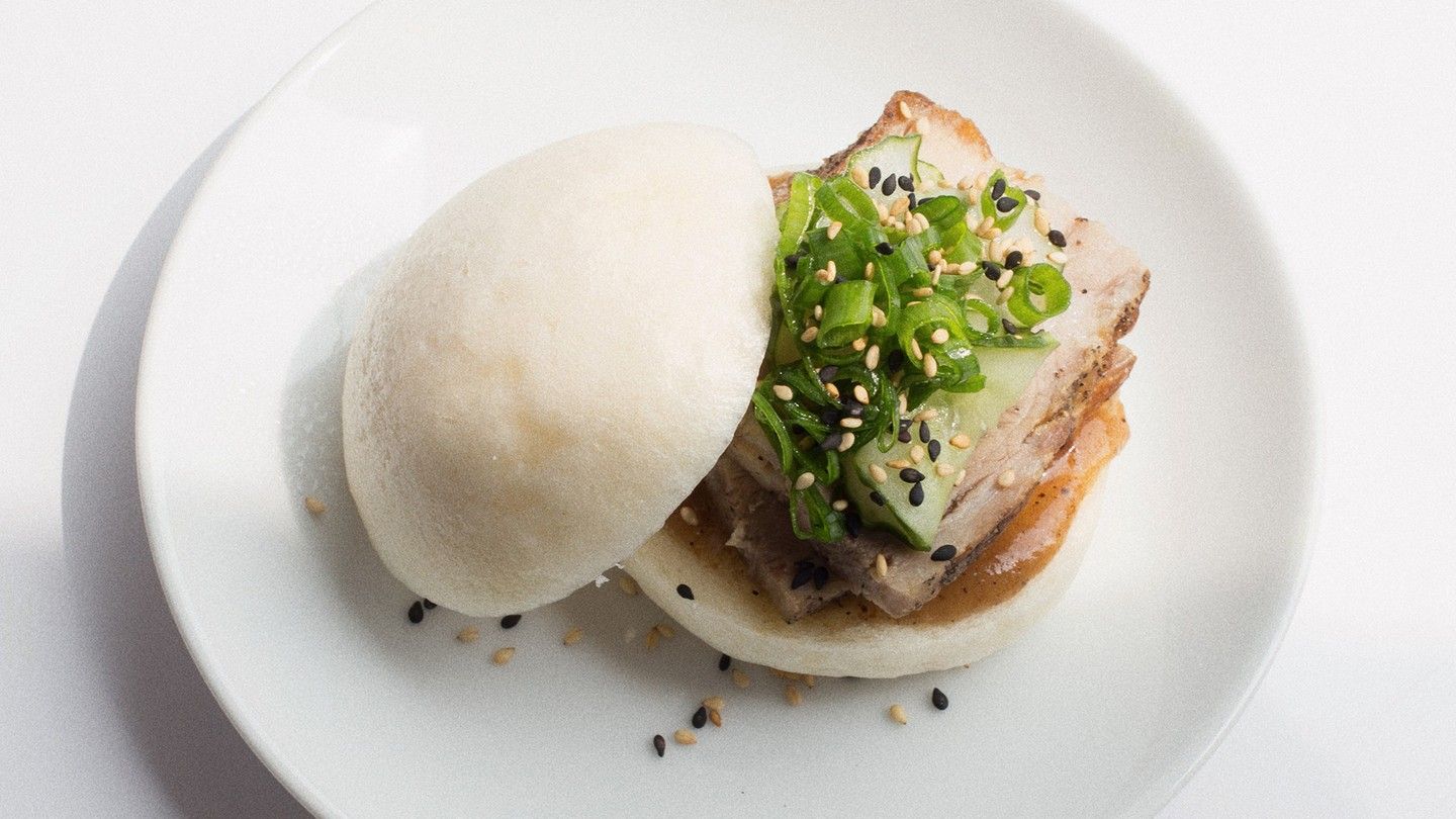 Steamed bao with crispy pork belly and fresh herbs