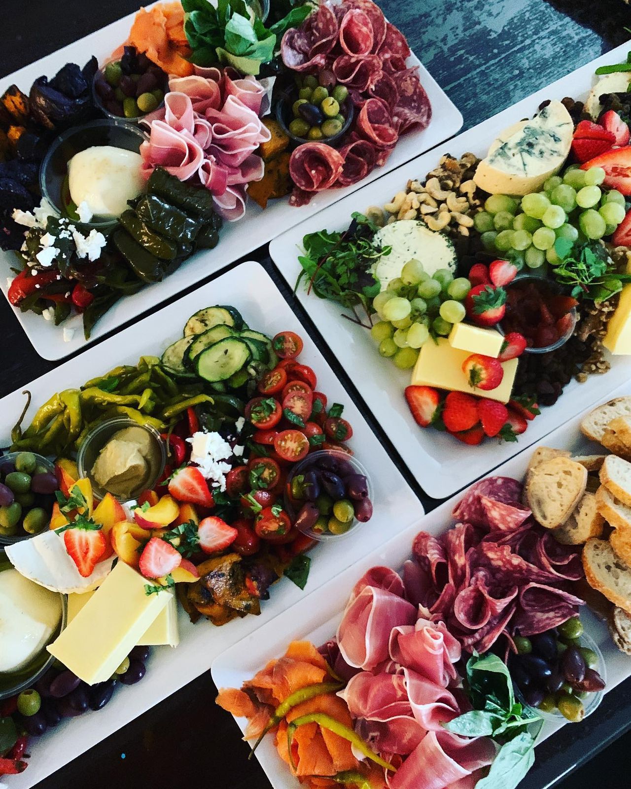 Shared platters of salads, cured meats and fresh produce