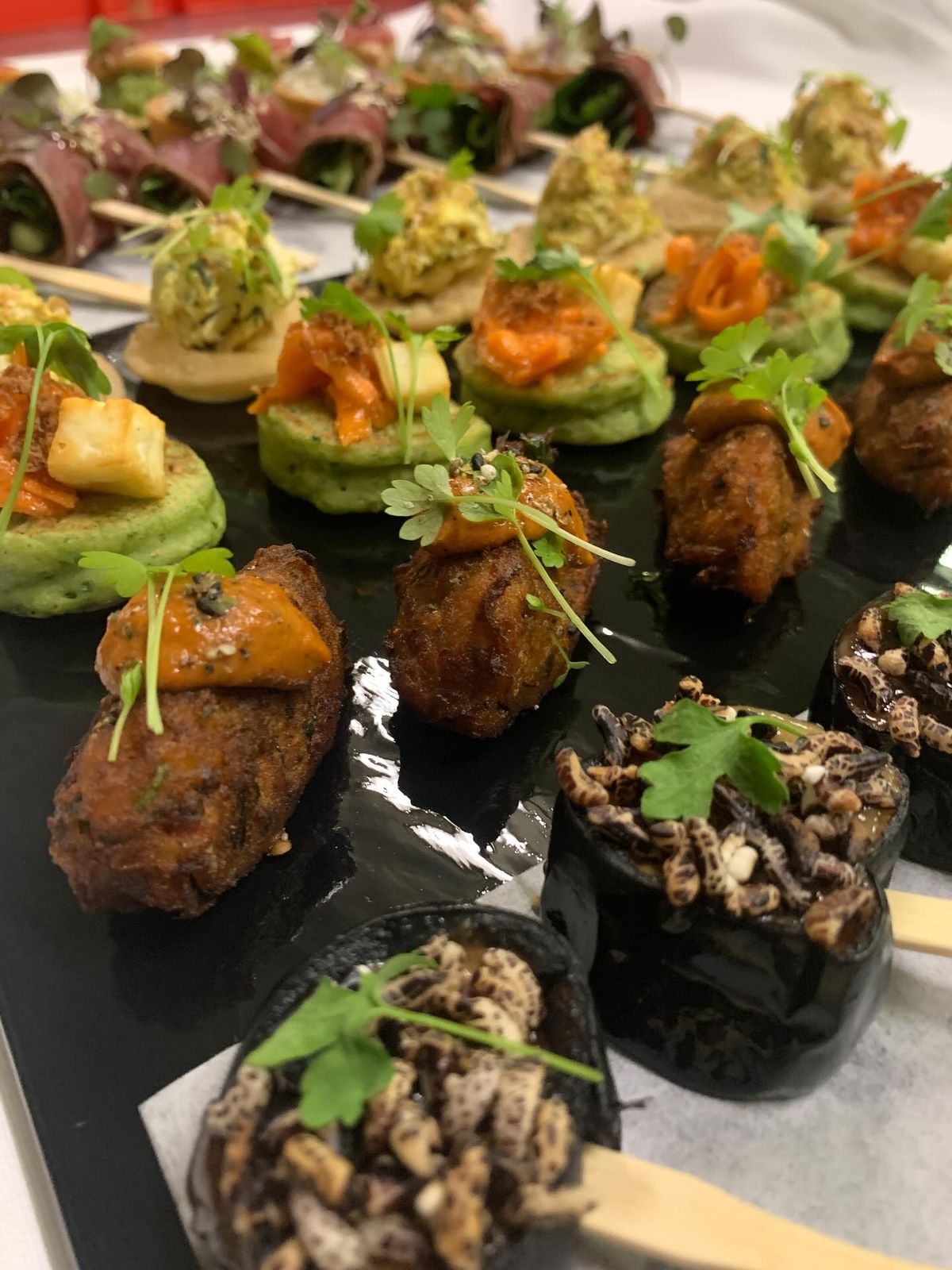 Gourmet canapés with fresh herb garnish